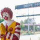 Ronald McDonald statue in front of McDonald's drive-thru
